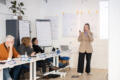 Lisa Urlbauer explains concepts to workshop participants sitting in chairs